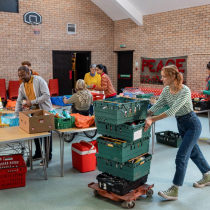 Volunteers work to sort food donations at a food bank. 