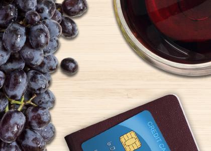 Wine, grapes, credit card and passport