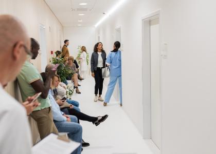 Hallway in a hospital filled with people waiting