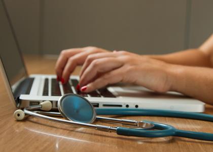 Medical examiner adding data on a laptop