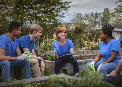 People sitting together in a community garden