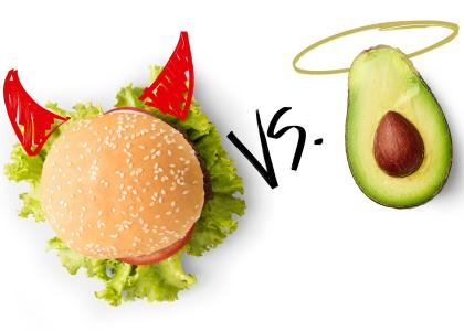 A hamburger with drawn-on devil horns sits beside an avocado with a drawn-on halo