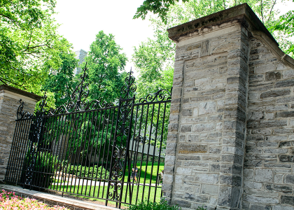 Photograph of the gates to campus from Allen Street