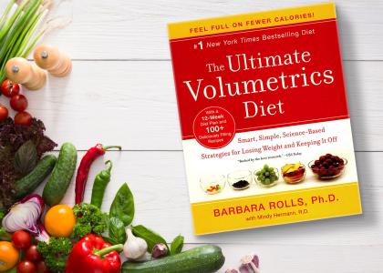The book 'Ultimate Volumetrics' on a white background with many vegetables around