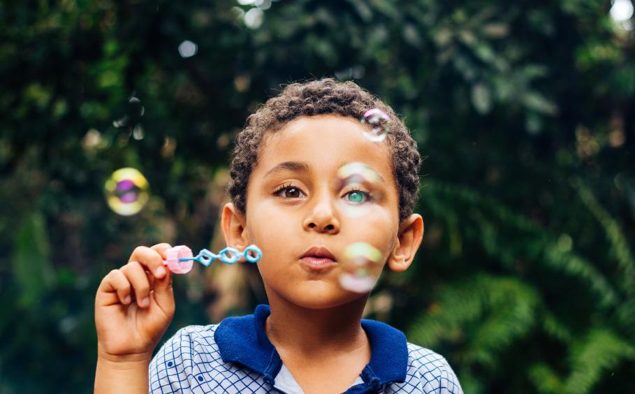 Boy playing with soap bubbles