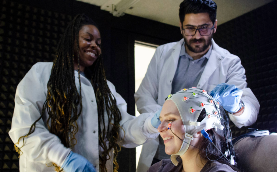 Graduate students prepare a participant with an fMRI cap