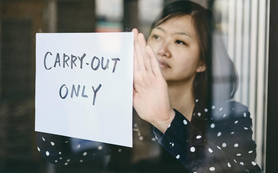 Woman posts "carry-out only" sign in restaurant window