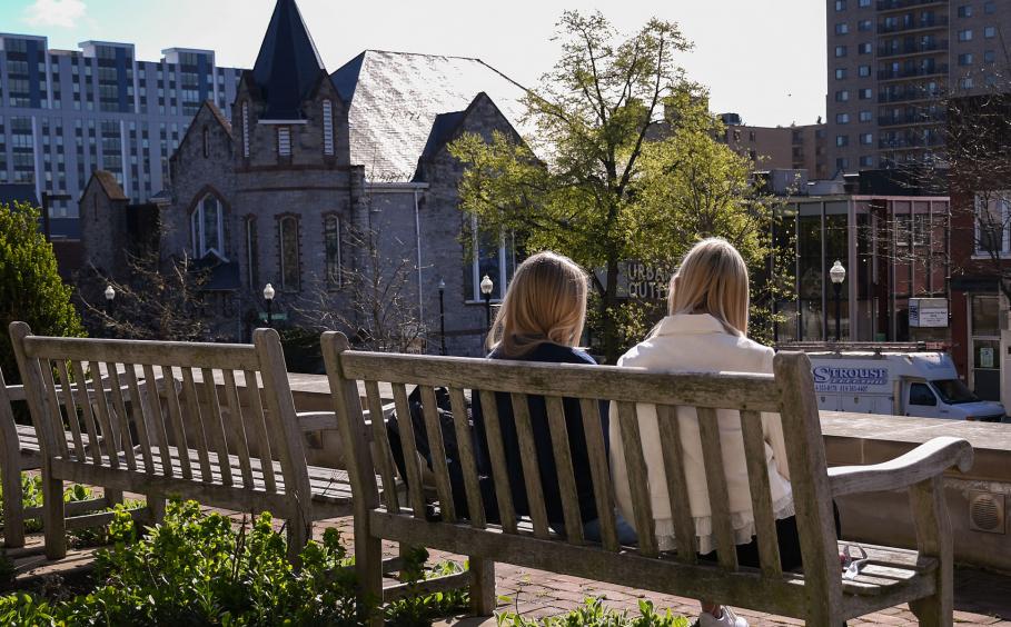 Student studying together on a bench on campus.