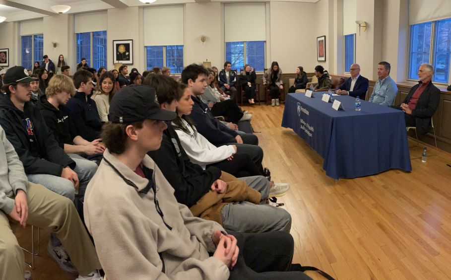 a room full of students attending a panel discussion.