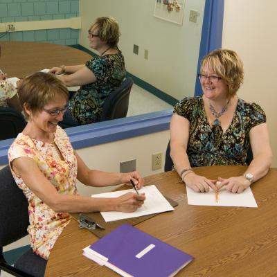 Connie Kossan works with an adult client in the Clinic