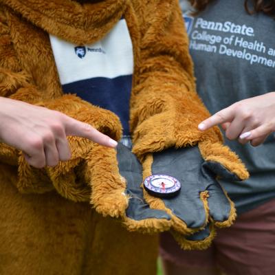 Compass in the palm of the Nittany Lion mascot. 