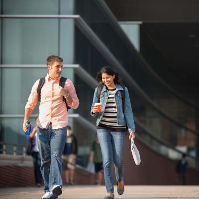 Two students walking on a walkway