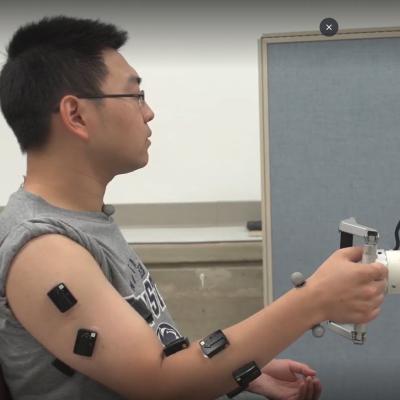 Man in lab has sensors along his arm