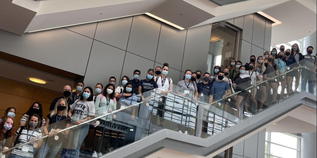 Students in masks on staircase