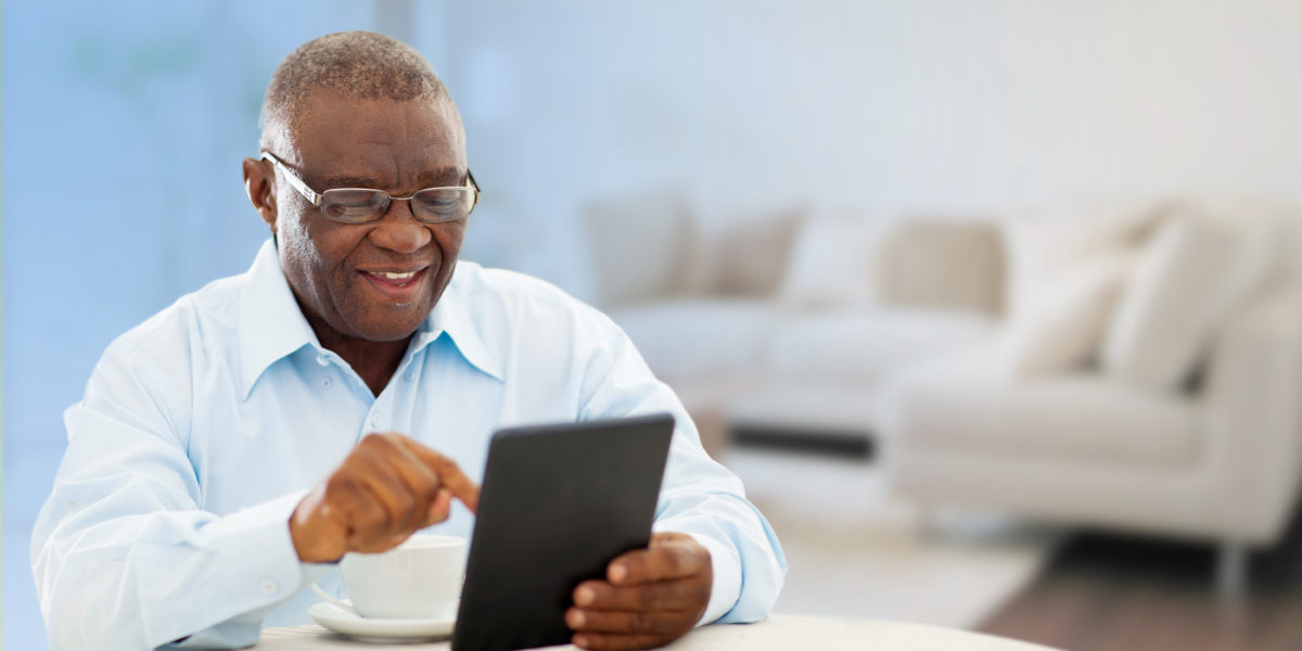 Older Black American using a tablet device