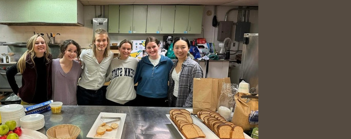 Members of the Culinary Medicine Club stand together for a group photo in the kitchen where they held their student soup kitchen night.