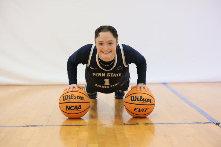 Elena doing a push-up on top of 2 basketballs