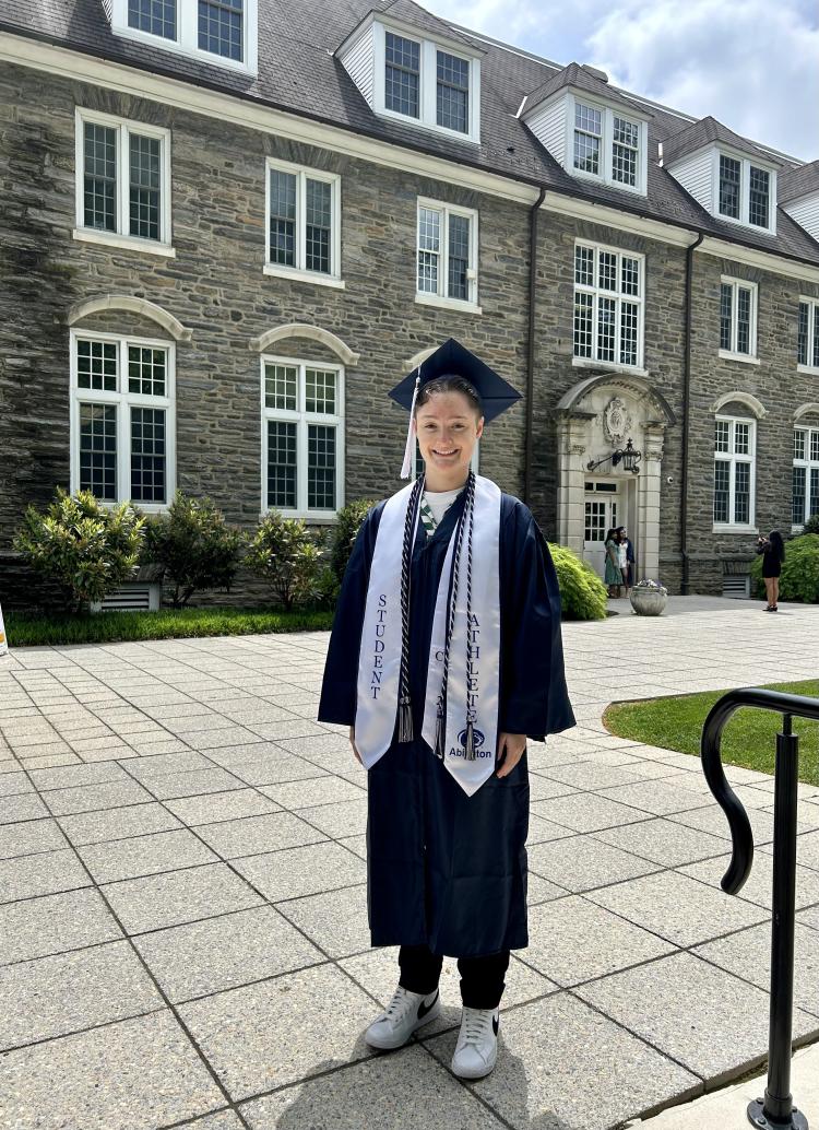 Elena wearing a cap and gown at May Graduation