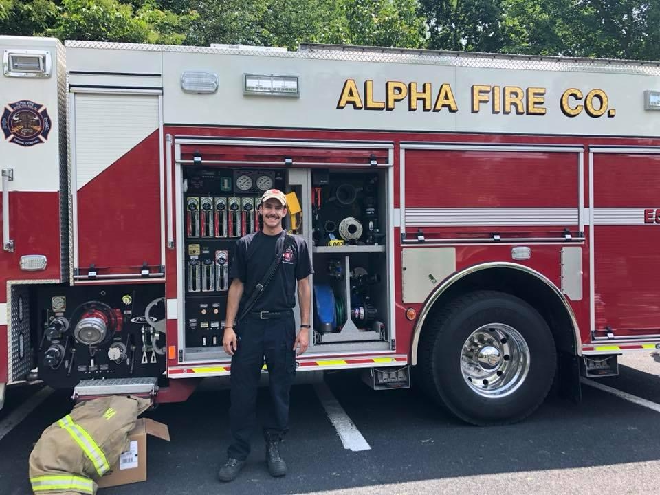 =Fireman Jon standing by Alpha Fire Company truck