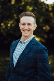 blonde man outside wearing blue suit